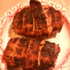 A picture of Bacon wrapped stuffed Pork chops.