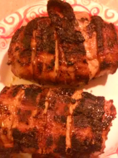 A picture of Bacon wrapped stuffed Pork chops.