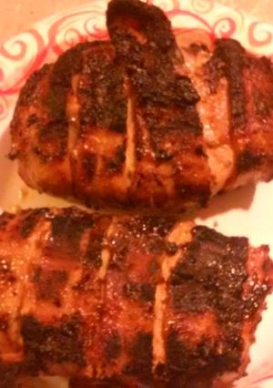 A picture of Bacon wrapped stuffed Pork chops.