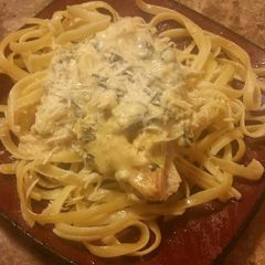 A picture of Spinach Artichoke Chicken with fettuccine.