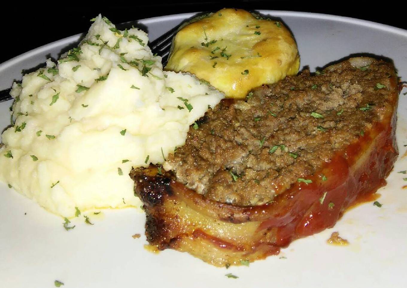 Slices of bacon wrapped in bacon on the floor