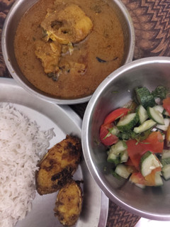 A picture of Salmon fish fry and curry with rice.