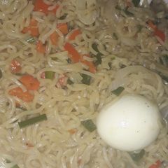 A picture of Noodles with boiled egg.