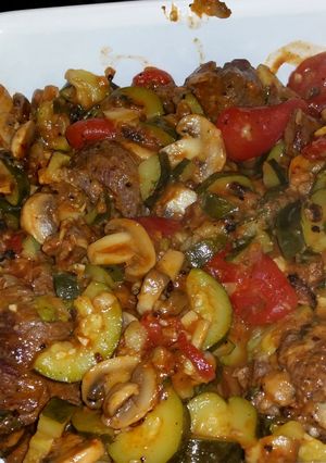 A picture of Braciole with chunky tomato-mushroom sauce.