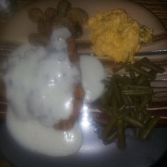 A picture of Down south chicken fried steak with cracked pepper white gravy.