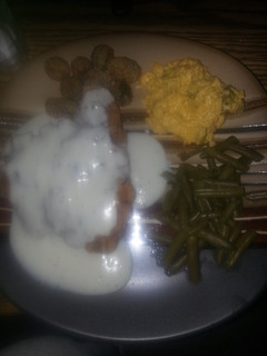 A picture of Down south chicken fried steak with cracked pepper white gravy.