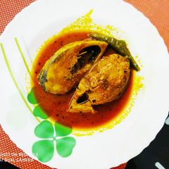 A picture of Ilish maccher tel jhal Hilsa fish curry.