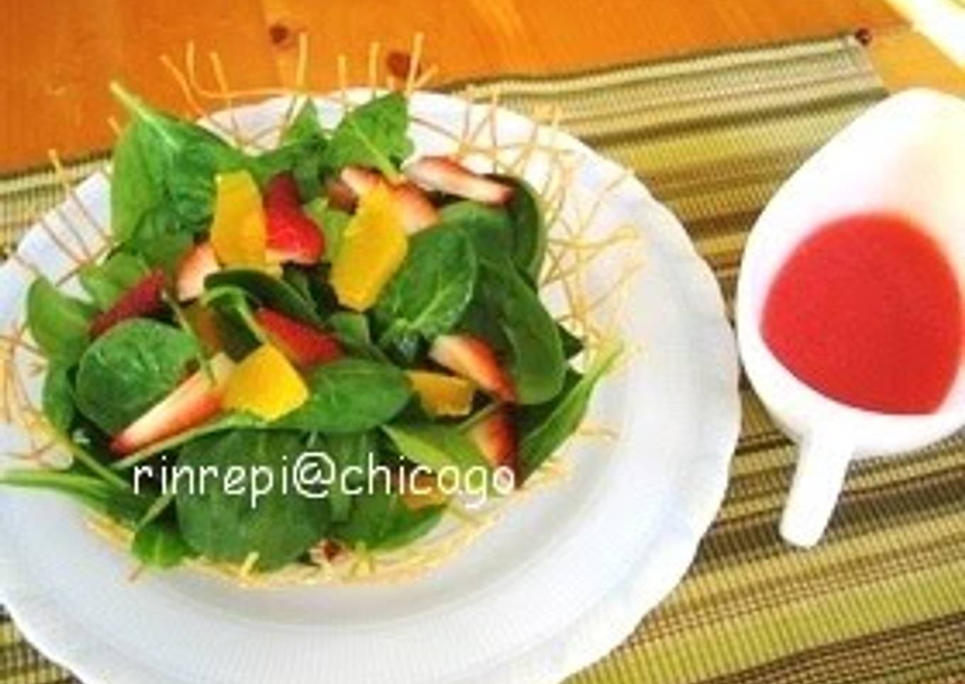 Salad with strawberry sauce in a basket with noodles