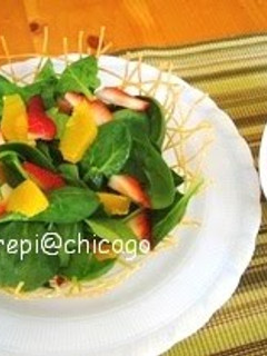A picture of Salad with Strawberry Dressing Served in a Noodle Basket.