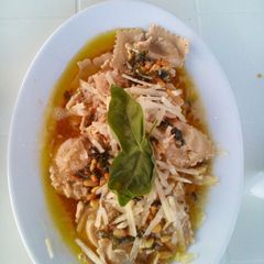 A picture of Mushroom Ravioli with a Buttery Sauce.