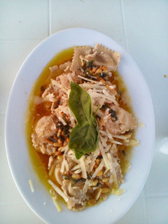 A picture of Mushroom Ravioli with a Buttery Sauce.