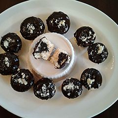 A picture of White Cupcakes with Chocolate Centers and Chocolate Glaze Icing.