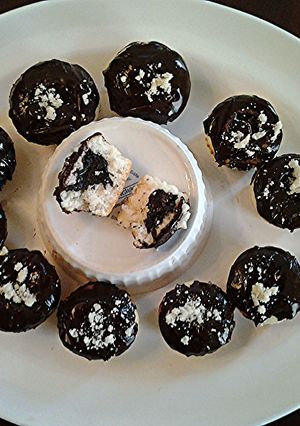 A picture of White Cupcakes with Chocolate Centers and Chocolate Glaze Icing.