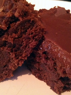 A picture of brownies with fudge icing.