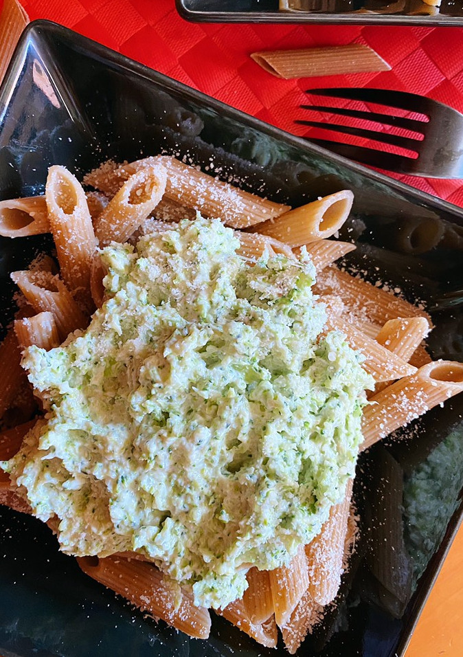 Una foto de Pasta integral con salsa de queso y brócoli