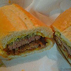 A picture of Lamb and beef on Cuban bread.