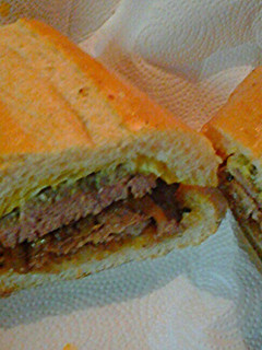 A picture of Lamb and beef on Cuban bread.