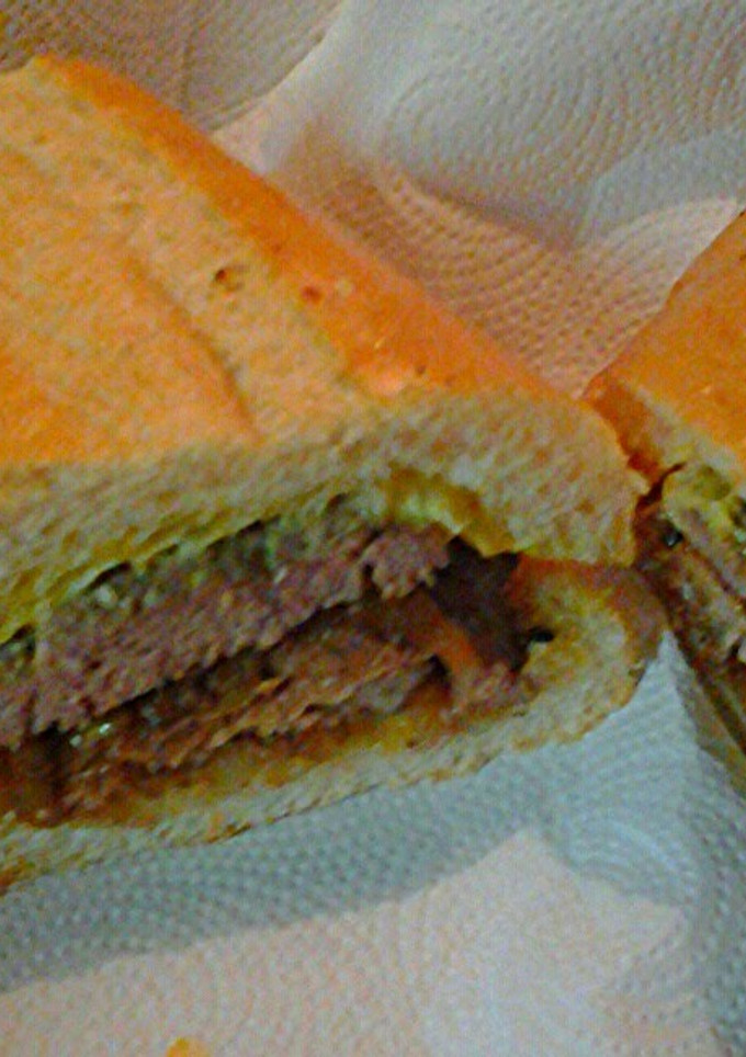 A picture of Lamb and beef on Cuban bread.
