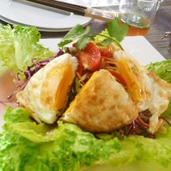 A picture of Thai-style Salad with Vegetables and a Sunny-side Up.