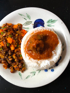 A picture of Rice and stew served with veggie beans.