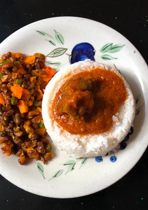 A picture of Rice and stew served with veggie beans.