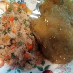 A picture of pork chops in green sauce.