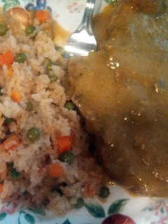 A picture of pork chops in green sauce.