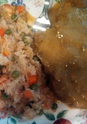 A picture of pork chops in green sauce.