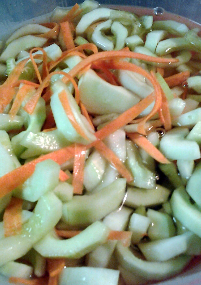 A picture of cucumbers and carrots in vinegar.