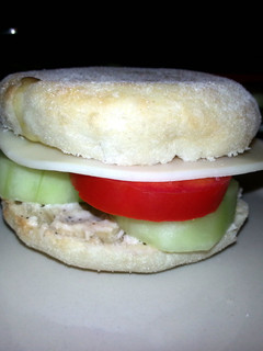 A picture of Taisen's english muffin w/tomato, cucumber, cheese and dressing.