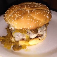 A picture of Cream cheese stuffed burgers this glazed onions and mushrooms.