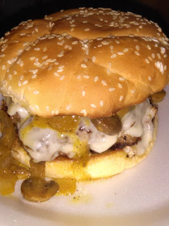 A picture of Cream cheese stuffed burgers this glazed onions and mushrooms.