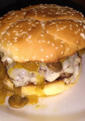 A picture of Cream cheese stuffed burgers this glazed onions and mushrooms.