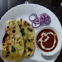 A picture of Dal Makhni With Garlic Naan.