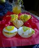 Pouched eggs with homemade turmeric and cream cheese sauce on english muffin
