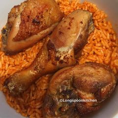 A picture of Jollof rice with fried chicken.