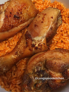 A picture of Jollof rice with fried chicken.