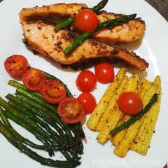 A picture of Smoked salmon with roasted asparagus,babycorns and tomatoes.