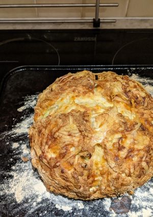 A picture of Soda bread with cheese and spring onions.