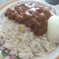 Rice with stew and boiled egg A picture of Rice with stew and boiled egg.