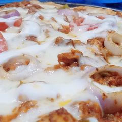 A picture of Homemade chicken tikka pizza with homemade pizza sauce.