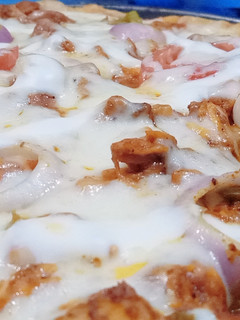 A picture of Homemade chicken tikka pizza with homemade pizza sauce.