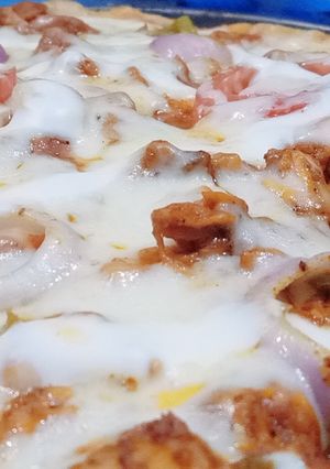 A picture of Homemade chicken tikka pizza with homemade pizza sauce.
