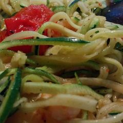 A picture of Spiralised courgette with baby prawns, roast baby tomatoes and pineapple in chilli pesto.
