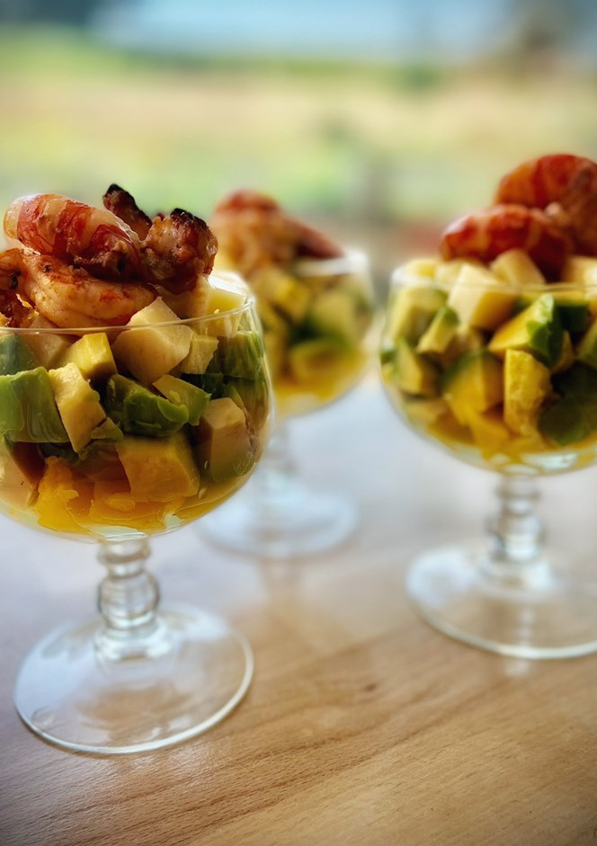 Una foto de Copas de aguacate, mango y queso con langostinos
