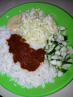A picture of White rice wit cucumber & cabbbage.
