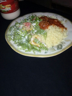 A picture of Rice and beef stew with salad.