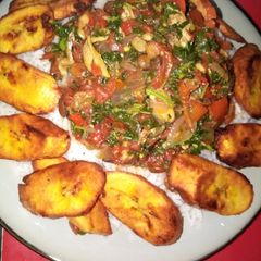 A picture of Tomato vegetable sauce with steamed white rice and fried plantai.
