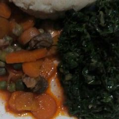 A picture of Ugali with beef stew and fried spinach.