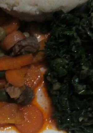 A picture of Ugali with beef stew and fried spinach.